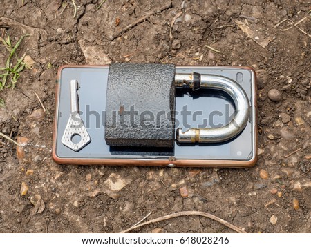 Smartphone, old key, lock - security idea, concept