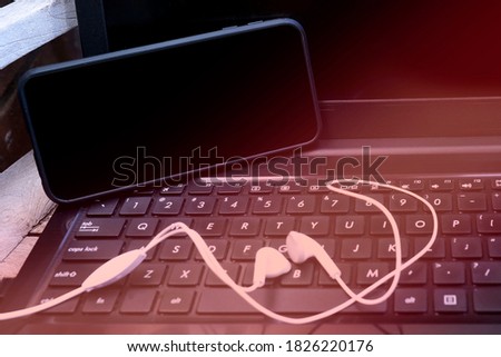 A smartphone on the computer keyboard 