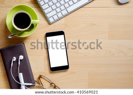 Smartphone on desk wooden table .