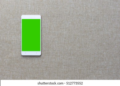 Smartphone With On Fabric Background, Greenscreen.