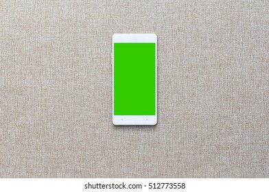 Smartphone With On Fabric Background, Greenscreen.