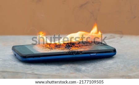 Smartphone on fire. The phone exploded from mishandling
