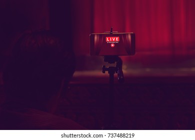 smartphone on tripod wait for video live streaming in theater, technology social concept - Shutterstock ID 737488219