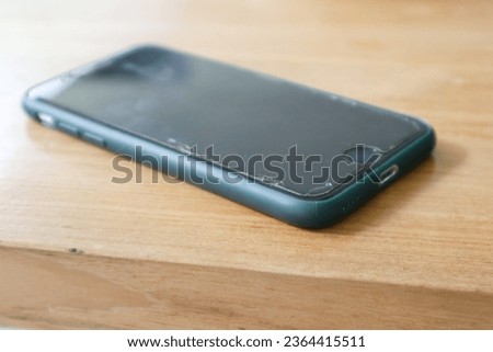 a smartphone over a wooden background