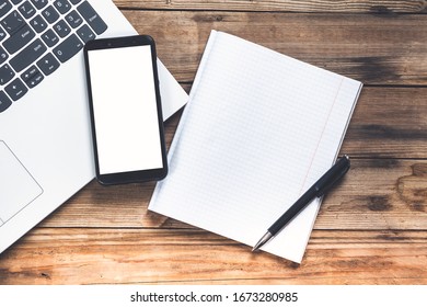 smartphone and pen on notepad on notebook laptop