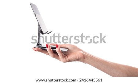 Smartphone in phone holder isolated on white background. Phone in female hands. Phone holder in hands. High quality photo