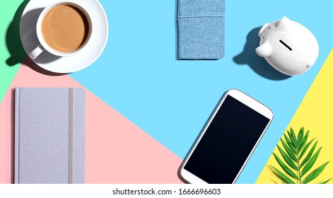 Smartphone With A Piggy Bank And Notebooks - Flat Lay