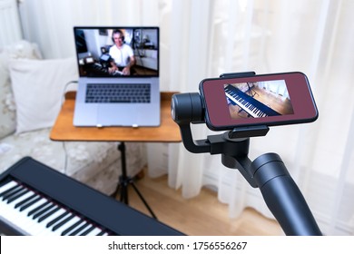 A Smartphone Placed On A Gimbal Used As Second Camera For Online Piano Lesson. DIstance Music Education Setup