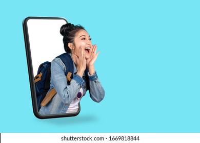 Smartphone pop up for advertising.Asian woman travel backpacker shouting open mouth through from screen mobile.Girl looking to aside copy space for present promotions.Digital marketing online cencept. - Shutterstock ID 1669818844