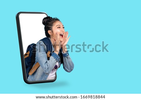 Smartphone pop up for advertising.Asian woman travel backpacker shouting open mouth through from screen mobile.Girl looking to aside copy space for present promotions.Digital marketing online cencept.