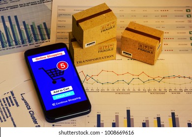 Smartphone Runs An Online Shopping App With Cardboard Boxes. Concept About This Type Of Financial Charts Include Stacks Of Bar Compare Between The Expansion Of Export Business For Goods Each Year.