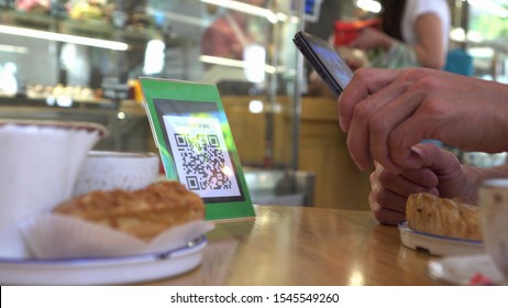 Smartphone scanning the recipient’s QR code. Mobile banking. Customers can pay through QR code, bank card, bank account or e-wallet by using payment gate - Powered by Shutterstock