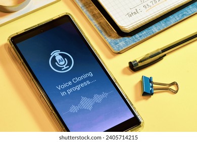 Smartphone screen displaying voice cloning using artificial intelligence in progress. Text to speech synthesis or real time voice cloning approach concept.