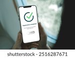 Smartphone screen shows Registration completed with Log in to proceed to the next step. The technological concept of project registration or membership application.