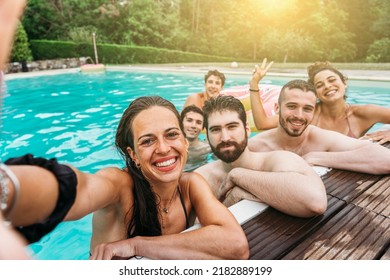 Smartphone self-portrait of a group of friends at the hotel outdoor pool during their summer vacation - Young people take a souvenir selfie photo in swimsuits having fun together in a relaxing moment - Shutterstock ID 2182889199