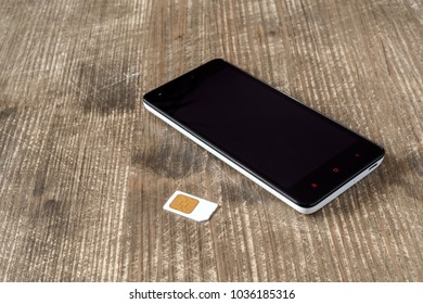 Smartphone And SIM Card On The Table