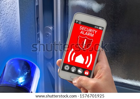 Smartphone with smarthome control app burglar alarm alert with flashing blue light