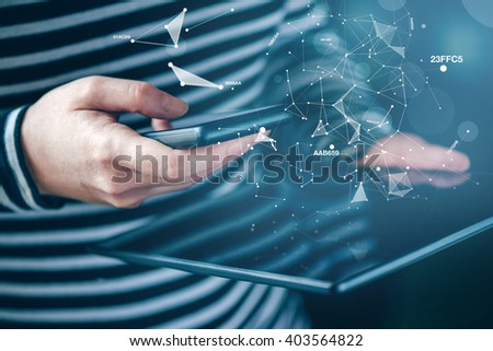 Smartphone and tablet data synchronization, woman syncing files and documents on personal wireless electronic devices at home, selective focus with shallow depth of field.