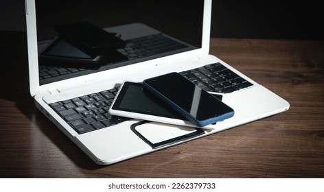 Smartphone, tablet, laptop computer on the wooden table. - Shutterstock ID 2262379733