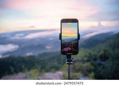 Smartphone Taking photo of mountain stream with  tripod nature view on screen at sunset. - Powered by Shutterstock