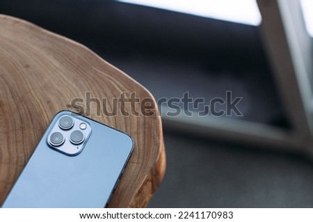 smartphone with three cameras on the table