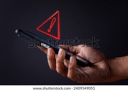 Smartphone with triangle caution warning icon. System error, malware and cyber crime concept. 