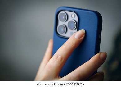 Smartphone With Triple-lens Camera In Women's Hands. Photos For Advertising Apps And Gadgets With Copy Space. Person Holds An IPhone 13 Pro In A Blue Case. Bishkek, Kyrgyzstan - January 24, 2022