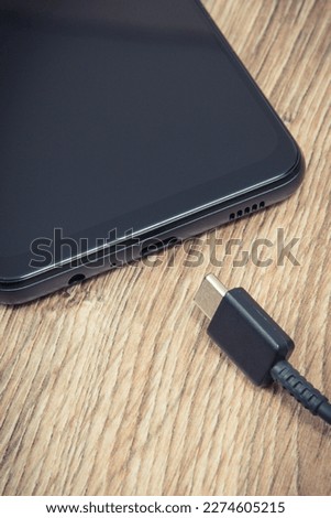 Smartphone and unconnected cable of charger. Mobile phone charging