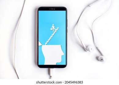 Smartphone With Uplifting And Business Prosper Concept, Paper Cut Open Head With Stairs Up.
