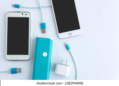 smartphone and USB cable charger with copy space - Shutterstock ID 1382994098