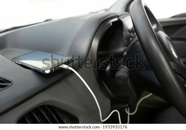 Smartphone with USB
charging cable in modern
car