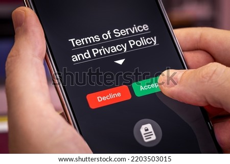 Smartphone user agrees to accept Terms of Service and Privacy Policy mobile app. Finger touches the Accept button. Dark app interface with Accept and Decline buttons