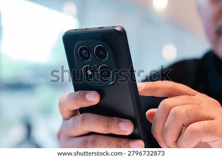 Smartphone User Browsing Mobile Applications in Modern Workspace