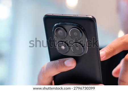 Smartphone User Managing Digital Tasks in Modern Cafe Workspace