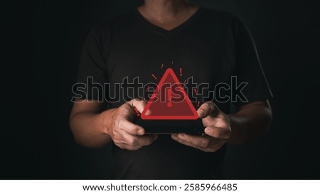 A smartphone user receives a caution notification as a glowing red warning symbol appears, indicating a potential error or alert in the digital system.