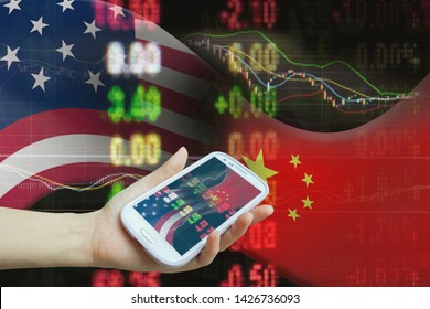 Smartphone Using For Stock Market Data On USA And China Trade War Economy With Business Planning Analysis By Online Technology. Hand Hold Smartphone Use Online Internet On USA China Trade War Economy