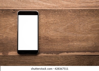 Smartphone with white screen On Wooden Table With Copyspace