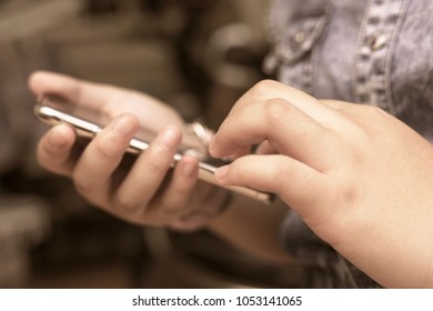 smartphone in young women hand or Close-up of woman using smartphone - Shutterstock ID 1053141065