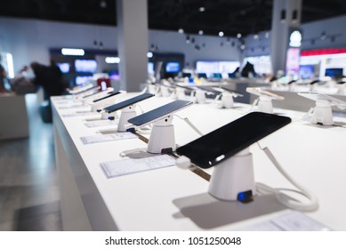 Smartphones on the background of the electronics store. Department of mobile phones in the tech store. A modern gadget store