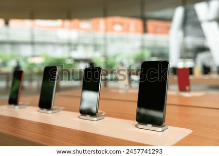 Smartphones on the shelf of the technology store. Department of mobile phones in the tech store. Technology concept.
