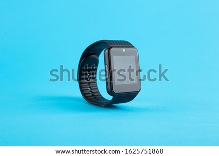 smartwatch black technological clock on blue background