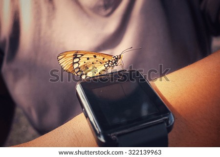Smartwatch with butterfly on hand