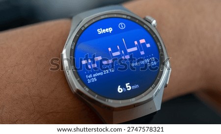 Smartwatch Displaying Sleep Cycle Graph and Nightly Rest Analytics