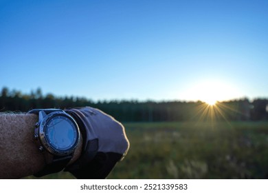 Smartwatch travel. Checking map on sports watch. Expedition smartwatch. Watch for wild survival. Hiking Watch on hand on sunset. GPS track in Smartwatch. Traveler with watch on hand in adventure.