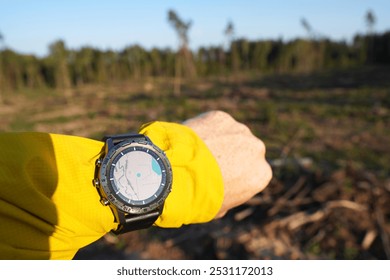 Smartwatch travel. Hiker checking map on sports watch. Expedition smartwatch. Watch for wild survival. Outdoor, hiking Watch on hand. GPS track in Smartwatch. Traveler with watch on hand in adventure. - Powered by Shutterstock