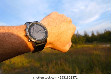 Smartwatch travel. Hiker checking the map altimeter on sports watch. Adventure and Expedition with smartwatch. Watch for survival in wild. Outdoor and hiking Watch on hand. Tactical GPS Smartwatch. - Powered by Shutterstock