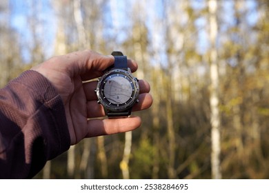 Smartwatch travel. Hiker checking map on tactical watch. Expedition smartwatch. Watch for survival. Outdoor, hiking Watch. GPS track in Smartwatch. Traveler with watch in hand in adventure. Compass. - Powered by Shutterstock