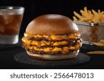 Smash burger with soda and fries in black backgraund