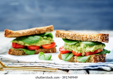 Smashed avocado spinach tomato grilled rye sandwich. toning. selective focus - Powered by Shutterstock