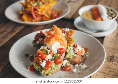 Smashed Avocado Toast With Salmon, Tomatoes And Feta